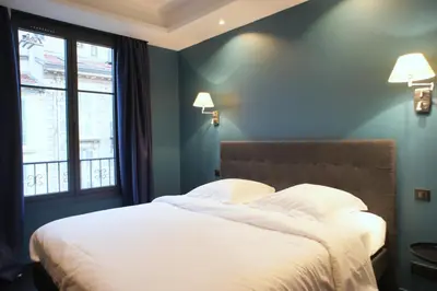 a bedroom with a bed with white sheets and a window at Ze Perfect Place - Élégant appartement avec terrasse - Promenade des Arts in Nice