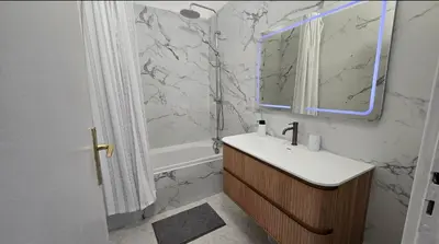 a bathroom with a sink and a tub and a counter at Les Grands Cedres D3 in Nice