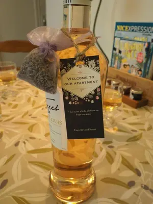 a bottle of wine sitting on top of a table at 2 Bedroom Apartment Old Town Centre in Nice