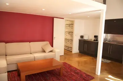 a living room with a couch and a table at AzurAppart Elegant Studio Centre in Nice