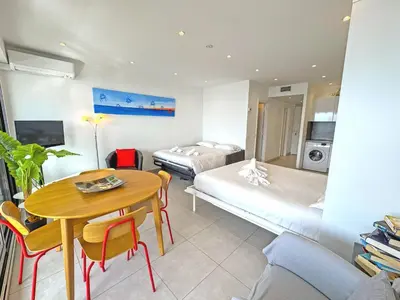 a hotel room with a table and a bed and a bedroom at PROMENADE HOLIDAY - ROYAL LUXEMBOURG PROMENADE in Nice