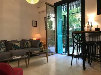 a living room with a couch and a table at Homelivia, Luxueux Appartement avec Jardin privé in Nice