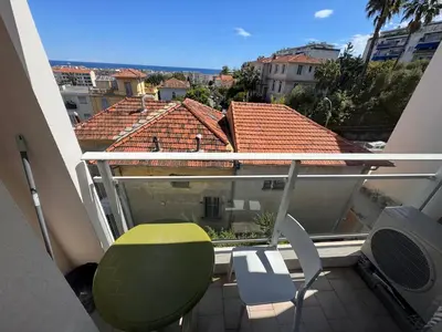a balcony with a table and chairs and a view at Nice Sunshine in Nice
