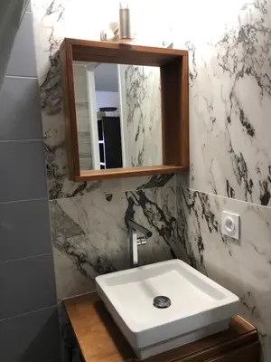 a bathroom with a white sink and a mirror at Nice Sunshine in Nice