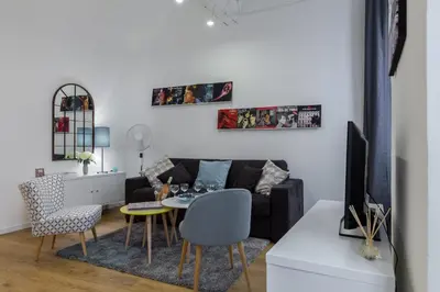 a living room with a couch and a table at Large one bedroom flat in the Old Town in Nice