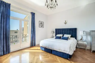 a bedroom with a bed and a large window at Semiramis in Villefranche-sur-Mer