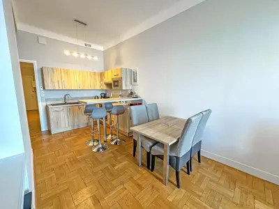 a kitchen with a wooden table and chairs in a room at PROMENADE HOLIDAY - ROCAMARE PROMENADE in Nice