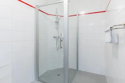 a shower with a glass door in a bathroom at Appart'City Classic Nice Acropolis in Nice
