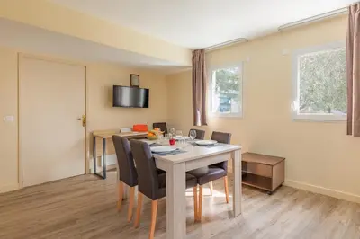 a dining room with a table and chairs at Appart'City Classic Nice Acropolis in Nice