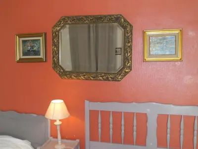 a bedroom with a mirror and a bed and a lamp at Villa Eden in Nice