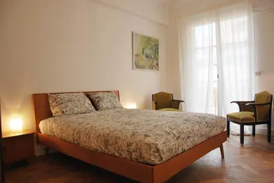 a bedroom with a bed and two chairs and a window at Les Gérardines by EnjoyNice, 3-room with Airco and balcony in Nice