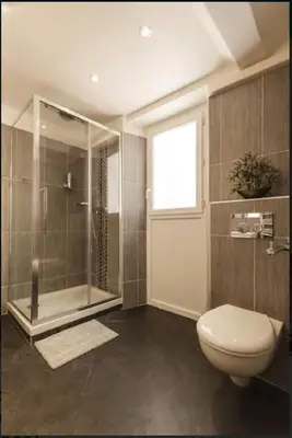 a bathroom with a shower and a toilet and a window at Nice Renting - COLONNA - Best place in Nice Old Town in Nice