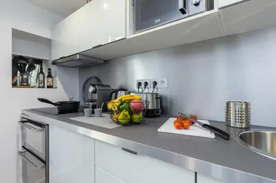 a small bedroom with a bed and a glass door at ANGLE DROIT- LOFT CHARMANT ET ATYPIQUE, CLIMATISATION, Vieux-Nice in Nice