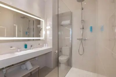 a bathroom with a shower and a sink and a toilet at Hotel 66 Nice in Nice