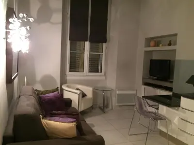 a living room with a couch and a table at Je suis à Nice in Nice