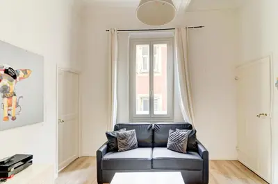 a living room with a couch and a window at Lovely Cosy Flat in Nice old town in Nice