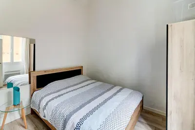 a bedroom with a bed and a glass table at Lovely Cosy Flat in Nice old town in Nice
