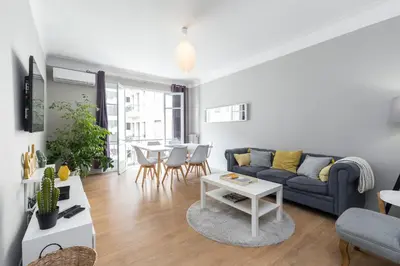a living room with a couch and a table at Ultra Central Large 2 Bdr near Massena Square in Nice