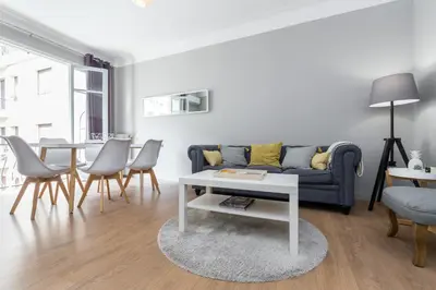 a living room with a couch and a table at Ultra Central Large 2 Bdr near Massena Square in Nice