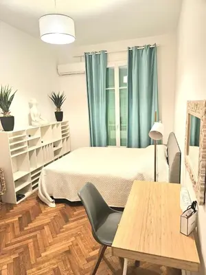 a bedroom with a bed and a table and chairs at Seaflat in Nice in Nice