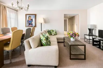 a living room with a couch and a table at La Résidence de La Réserve in Beaulieu-sur-Mer