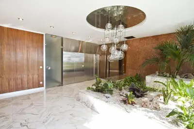 a large lobby with plants and a chandelier at PROMENADE HOLIDAY - COSY SEA FRONT STUDIO in Nice