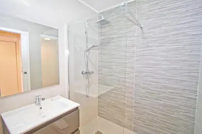 a bathroom with a glass shower and a sink at PROMENADE HOLIDAY - COSY SEA FRONT STUDIO in Nice