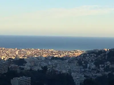 a view of a city at night with the ocean at B&B Villa sensorielle in Nice