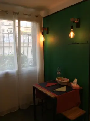 a green room with a table and a window at Studio 33 in Nice