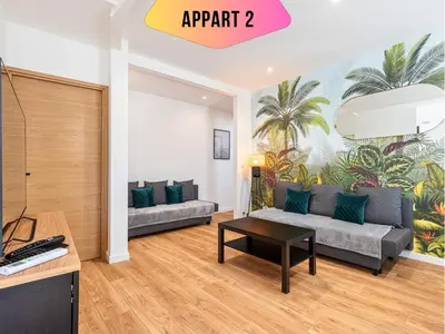 a living room with a couch and a table at CASA REINE JEANNE- ideal groups & family -CENTRAL near train station - PARKING - New&CONFORT-AC in Nice