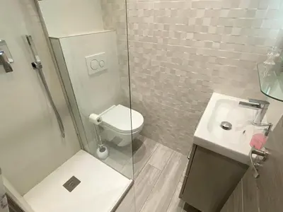 a small bathroom with a toilet and a sink at Nice Centre Flat - Modern, Quiet and Brand New in Nice