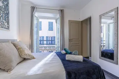 a bedroom with a large bed and a large window at MY CASA - PARADIS - Carré d Or 1 room - Balcony Sea View in Nice