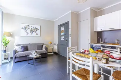 a kitchen and a living room with a table and chairs at MY CASA - PARADIS - Carré d Or 1 room - Balcony Sea View in Nice