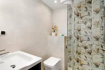 a bathroom with a shower and a toilet and a sink at Les Oranges Five Stars HolidayHouse in Nice