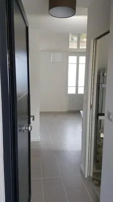 an empty room with a door and a tile floor at Maison / Appart Le PIOL in Nice
