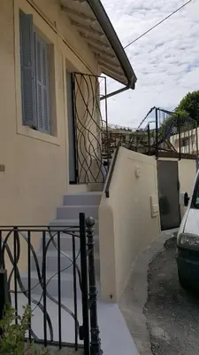 a house with a staircase in front of a house at Maison / Appart Le PIOL in Nice
