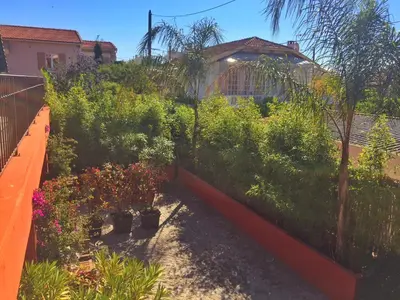 a garden with plants and flowers on a fence at Villa du Cros in Cagnes-sur-Mer
