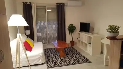 a living room with a white couch and a television at Nissa La Bella in Nice