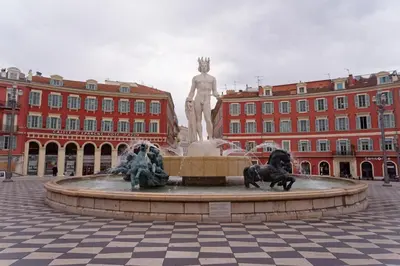 a fountain with two statues in front of a building at Nissa La Bella in Nice