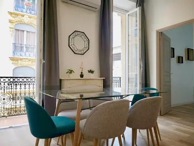 a dining room with a glass table and chairs at Appartement Urban 3 in Nice