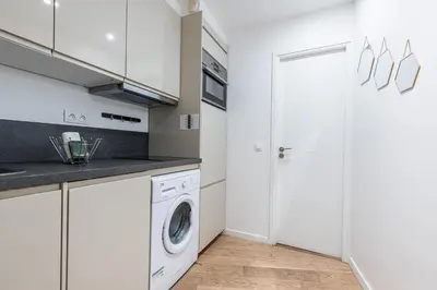 a white laundry room with a washer and dryer at Quiet and cosy 1bdr in Vieux Nice! in Nice