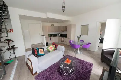 a living room with a white couch and a purple rug at La Garibaldi in Nice