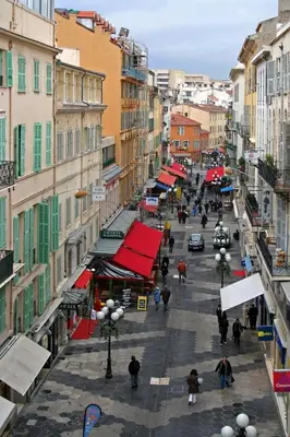 a city street with people walking down a street with buildings at Irene Apartment in Nice