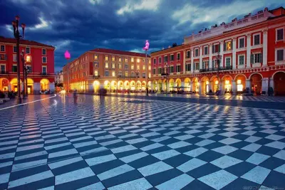 a city square with buildings and a checkered floor at Irene Apartment in Nice