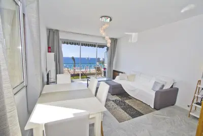 a living room with white furniture and a view of the ocean at MILORD PROMENADE 2 - PROMENADE HOLIDAY in Nice