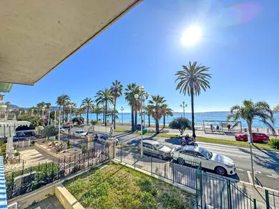 a view of a street with palm trees and the ocean at CARIATIDES STUDIO - PROMENADE HOLIDAY in Nice