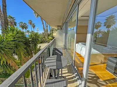 a balcony of a house with a bed and a table at CARIATIDES STUDIO - PROMENADE HOLIDAY in Nice