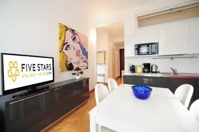a living room with a tv and a kitchen at Suite Halevy 5 stars Holiday House in Nice