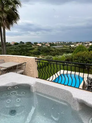 a hot tub on a balcony with a fence at Villa Antoline in Cagnes-sur-Mer