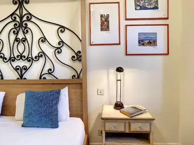 a bedroom with a bed and a table with a lamp at Nestor&Jeeves - SIXTIES - Central - Very close sea - Retro in Nice